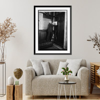 Historic Framed Print, Cannon removing picture from wall, 3/3/23,  17-7/8" x 21-7/8"