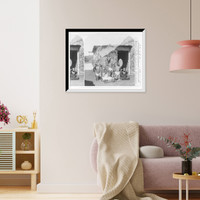 Historic Framed Print, Group of natives eating poi Hawaiian Islands [in front of grass hut],  17-7/8" x 21-7/8"