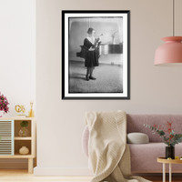 Historic Framed Print, Rubinstein holding violin, looking at it, near piano,  17-7/8" x 21-7/8"