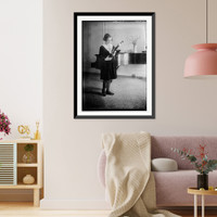 Historic Framed Print, Rubinstein holding violin, looking at it, near piano - 2,  17-7/8" x 21-7/8"