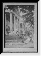 Mansion portico with costumed ladies, possibly a museum, Vintage Print
