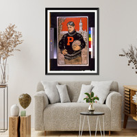 Historic Framed Print, [Princeton student with letter P on sweater half-length standing facing left holding football(?) with Princeton University behind him]. John E. Sheridan.,  17-7/8" x 21-7/8"