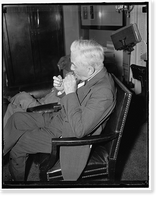 Veteran Nebraska Senator. Washington, D.C., May 15. Senator George W. Norris, Independent-Republican from Nebraska, lights a stogie while attending the Senate Judiciary hearing the other day, 5/15/