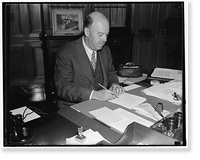 New Commissioner of Immigration. Washington, D.C., Aug. 26. James L. Houghsteling, of Chicago, photographed at his desk shortly after he took the oath of office as U.S. Commissioner of Immigration
