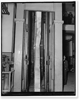 Steel bending. Washington, D.C., Sept. 23. Photo shows the welded steel knees in the 600,000 lb. testing machine at the U.S. Bureau of Standards today, as it buckled under 153,600 lb. maximum load