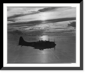 Douglas dive bomber returns to base after patrol flight as sun sets across the Pacific, Historic Print