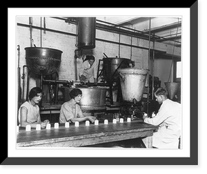Two men and two women putting face cream into jars at a factory in Chicago, Vintage Wall Art
