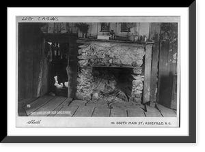 Interior of an old log cabin, shows fireplace and a child holding a smaller child inside doorway of an adjoining room, Historic Print