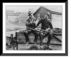 2 men seated on a wagon and holding 2 rabbits and 2 shotguns, Historic Reproduction