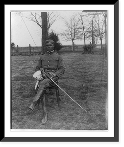Historic Framed Print, [25th anniversary of Tuskegee Inst., Ala., 1906: Young man in uniform seated on lawn],  17-7/8" x 21-7/8"