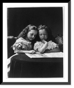 Historic Framed Print, [Two small girls reading at small round table],  17-7/8" x 21-7/8"