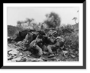 Korean Conflict. Men of the 3rd Battalion, 34th Infantry Regiment, 35th Infantry Division, covering up behind rocks to shield themselves from exploding mortar shells, near the Hantan River in centr