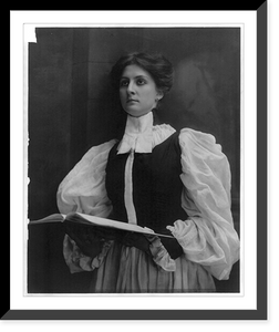 Historic Framed Print, [Young woman modeling: half lgth., standing in choir robe, holding open music book],  17-7/8" x 21-7/8"