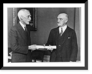 Secretary of the Treasury Andrew Mellon presents Walter E. Hope, of New York, who was sworn in today as Assistant Secretary of the Treasury, with his commission shortly after the ceremony at Washin
