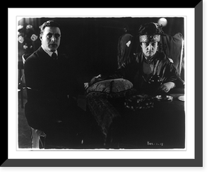 Do you believe in spirits? George Walsh, Fox movie star, is seen gazing intently into space while a medium talks to the spirits Classic, Antique Wall Art