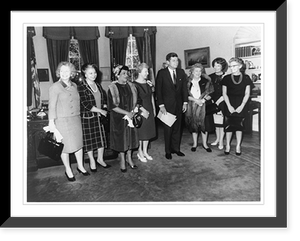 President John Fitzgerald Kennedy, full-length portrait, standing, facing right; with seven women in office in the White House, Antique Poster