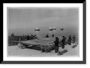 Buryat-Mongolian Autonomous Soviet Socialist Republic: men mending nets, with four boats on water in background Classic, Vintage Print