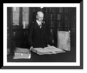 Historic Framed Print, [Herbert Putnam, half-length portrait, standing, facing right, with the three volume Gutenberg Bible, Library of Congress],  17-7/8" x 21-7/8"