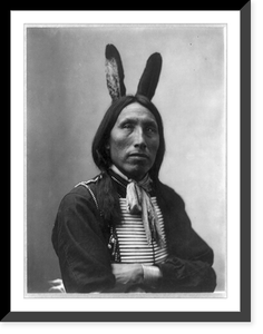 James Lone Elk, Dakota Indian, half-length portrait, facing left with arms folded; wearing bone breast plate and feathers in hair Classic, Antique Print