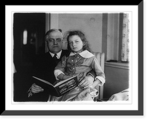 Alexander Mitchell Palmer, three-quarter-length portrait, seated facing front, with girl on his lap, holding book, Antique Print