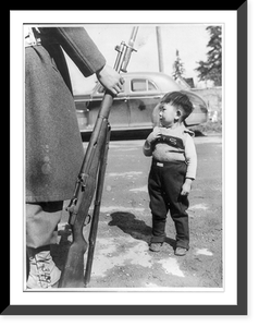 Young Japanese boy standing beside rifle held by soldier during evacuation of Bainbridge Island, Wash, Vintage Wall Art