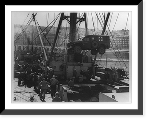 Mercy trucks accompany invaders; U.S. Coast Guardsmen load an ambulance aboard their transport at a North African port as they prepare to sail for Sicily, Vintage Print