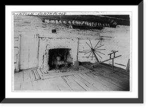 An Interior view of the original Lincoln cabin showing the old fireplace in the west room and the old spinning jenny of Mrs. Lincoln, Historic Print