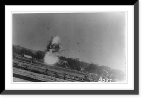 Historic Framed Print, [German airplane exploding over open field after being shot down by American plane, with one wing still visible],  17-7/8" x 21-7/8"