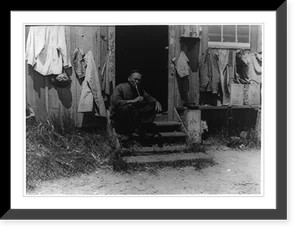 Man smoking pipe in shack doorway, San Pedro Chinatown, Antique Poster