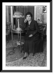 Amy Castles, full length portrait, seated, facing mostly left. Australian singer, Historic Reproduction