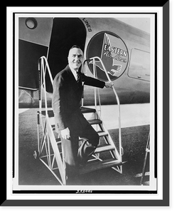 Edward Vernon Rickenbacker, full-length portrait, standing on steps to Eastern Air Lines airplane, facing front, Vintage Print