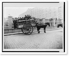Black & White Photo - Immigrants being transported on horse-drawn