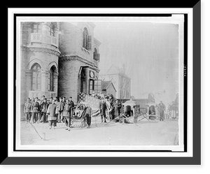 Asian men and Americans posed in front of building entranceway which is draped with an American flag, a girl sitting in a rickshaw and two sedan chairs, probably in China Heritage Wall Art Print