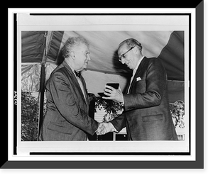 Edgard Varese shaking hands with Aaron Copland, with Mr. Copland receiving presentation, standing, half-length.Bernice B. Perry, Wilton, New Hampshire, Historic Print