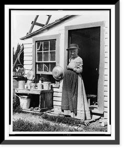Elderly woman, standing at doorway, on Mackinac Island, Michigan, Historic Reproduction