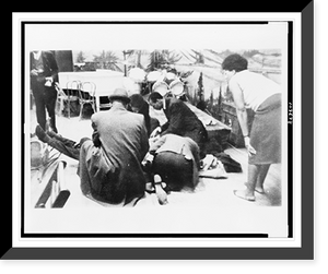 Historic Framed Print, Followers of Malcolm X try to comfort firey renegade of the negro radical movement, as he lies mortally wounded on stage in an upper Manhattan ballroom Feb. 21, after he was cut down by bullets - 2,  17-7/8" x 21-7/8"