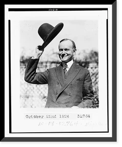 Calvin Coolidge, half-length portrait, standing, facing left, tipping his hat, Historic Print