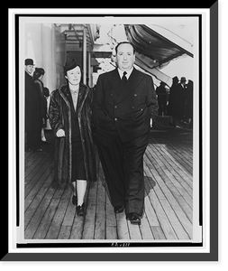 Alfred Hitchcock and his wife, Alma Reville, full-length portraits, walking on deck of the SS Queen Mary.Cosmo-Sileo Co. Classic, Vintage Print