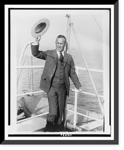 Historic Framed Print, [Lincoln Ellsworth, full-length portrait, standing on boat, facing slightly left, holding up hat],  17-7/8" x 21-7/8"