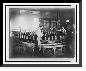 Historic Framed Print, [Boys pouring wax(?) into molds in factory],  17-7/8" x 21-7/8"