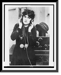 Anne Cornwall, half-length portrait, standing, facing front, listening to radio in Paramount studio, Los Angeles Classic, Antique Print
