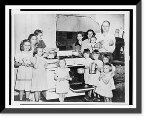 Mr. and Mrs. Lloyd Brooks of Pittsfield, Maine, and their twelve daughters posed around stove in kitchen, Vintage Print