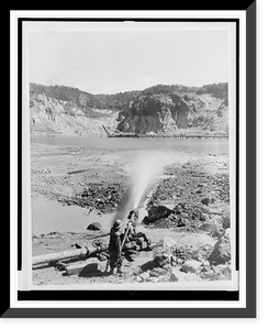 A high-pressure hydraulic jet disintegrates clay on what was once the bottom of Steep Rock Lake, Ontario, so that iron ore can be mined, Antique Print