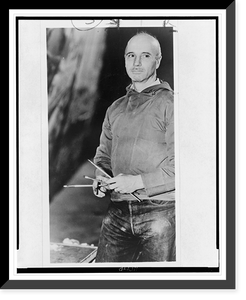 Rockwell Kent, three-quarter length portrait, facing left, holding paint brushes, Antique Print