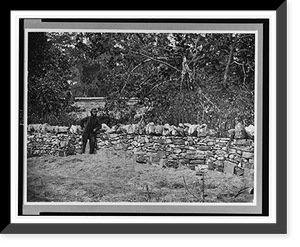 Historic Framed Print, [Soldier standing at graves of Federal soldiers, along stone fence, at Burnside Bridge, Antietam, Maryland],  17-7/8" x 21-7/8"