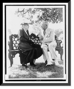 Harry S. Truman and Edith Bolling Galt Wilson, full-length portrait, seated on outdoor bench, facing each other, Antique Poster