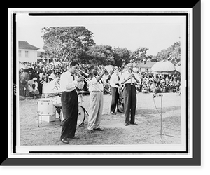 Historic Framed Print, [Louis Armstrong, full-length portrait, playing trumpet with band at an outdoor gathering, Africa],  17-7/8" x 21-7/8"