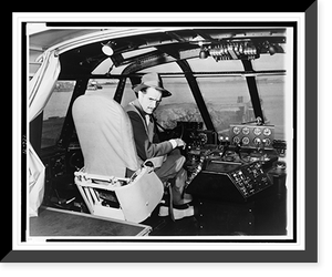 Howard Hughes, seated in cockpit of wooden flying boat, turned right, facing front, Antique Poster