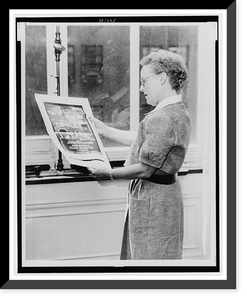 Alma Hitchcock, three-quarter length portrait, left profile, holding poster of Alfred Hitchcock's film, Rear window"", Vintage Wall Art