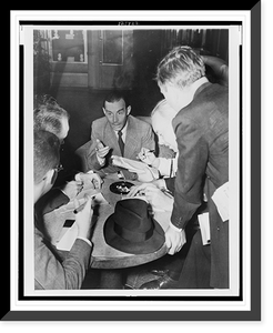 Historic Framed Print, [Erich Maria Remarque, seated, surrounded by reporters aboard the S.S. Queen Mary as it arrives in New York],  17-7/8" x 21-7/8"